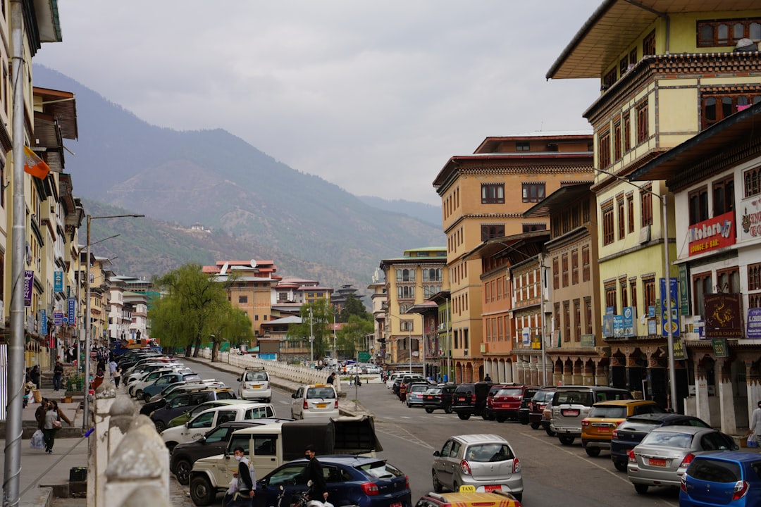 A street in Thimphu, Bhutan's capital, with traditional buildings and mountains beyond