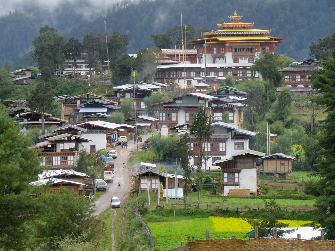 Hillside village above a Bhutanese valley on the classic west-Bhutan circuit