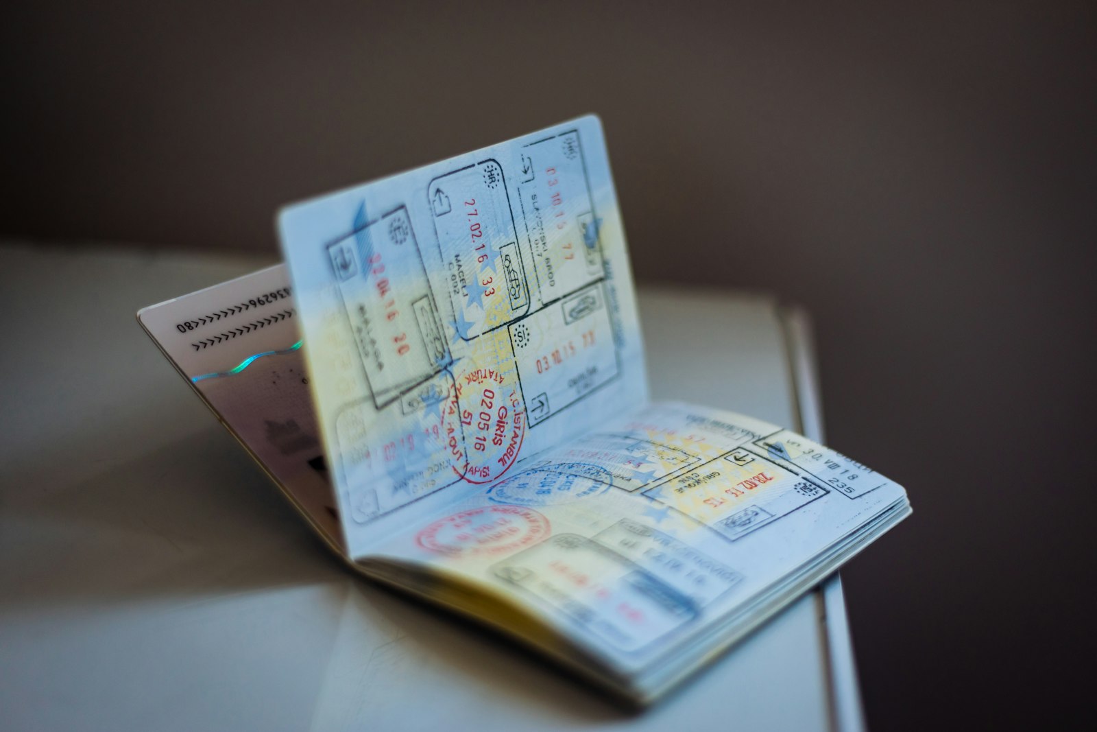 An open passport covered in immigration stamps